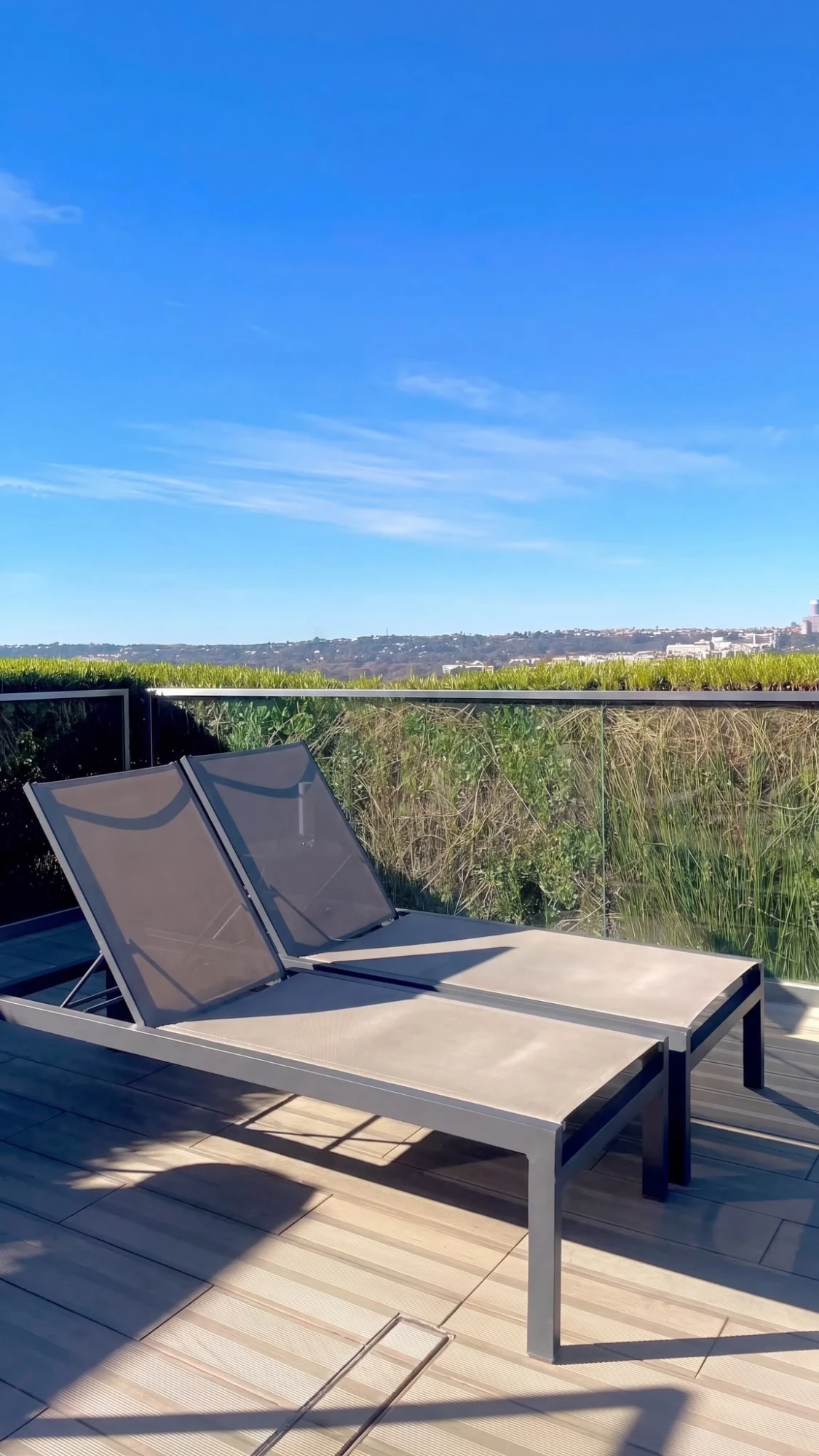 Avant transat vide sur une terrasse, puis une personne ajoutée au soleil
